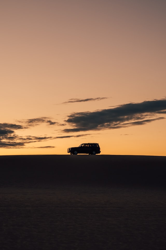 An SUV on a Sri Lankan ridge at golden hour